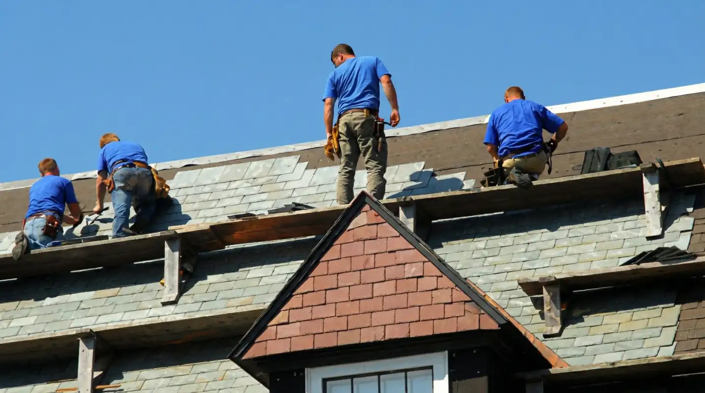 Roof replacement in progress with a team of professional contractors installing new shingles on a residential home in Pasadena, CA